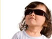 A little girl with curly hair and sun glasses